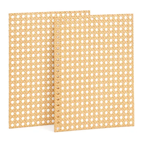 Two matching open weave cane webbing sheets leaning upright side by side on a white background