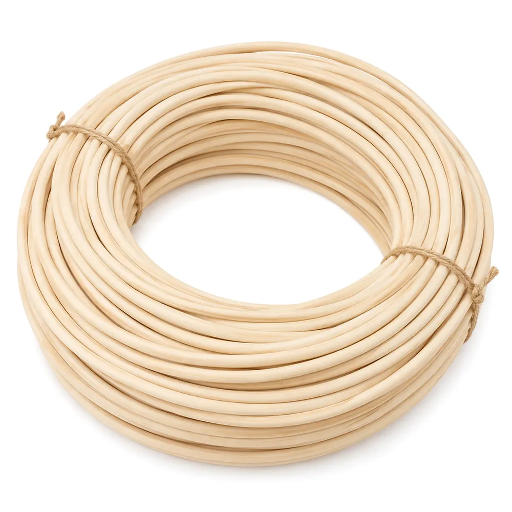 Large coil of natural reed spline loosely tied with two twists of twine on a white background