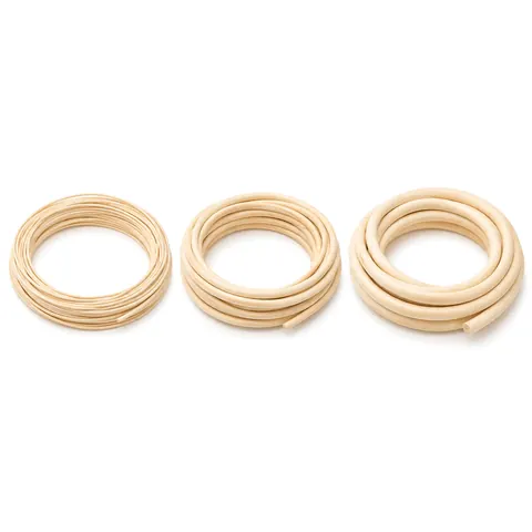 Three small coils of natural reed spline side by side in three thicknesses on a white background