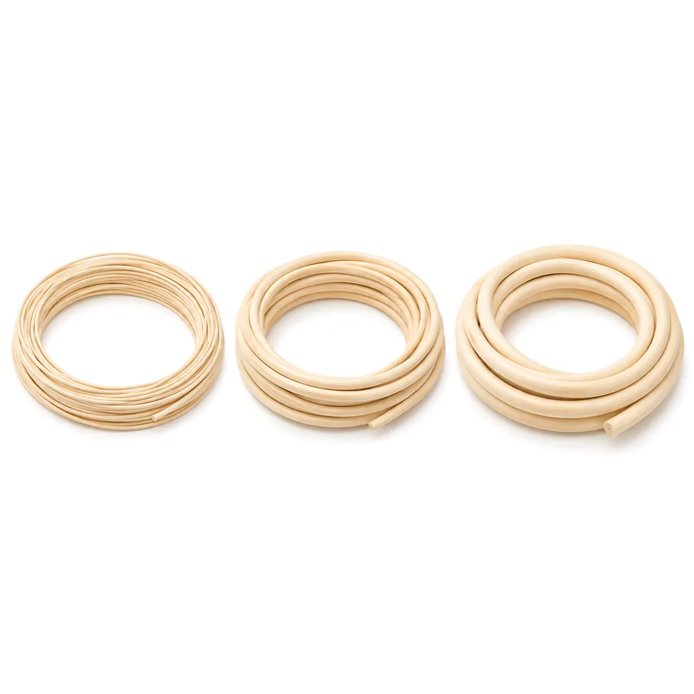 Three small coils of natural reed spline side by side in three thicknesses on a white background