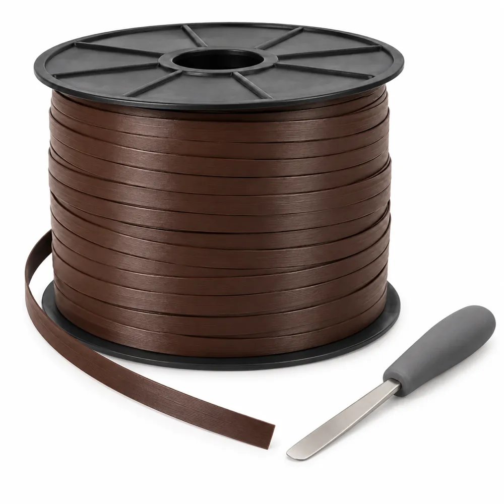 Reel of dark brown flat PE wicker strip with a loose end and a stainless steel prying tool on warm peach paper, on a white background