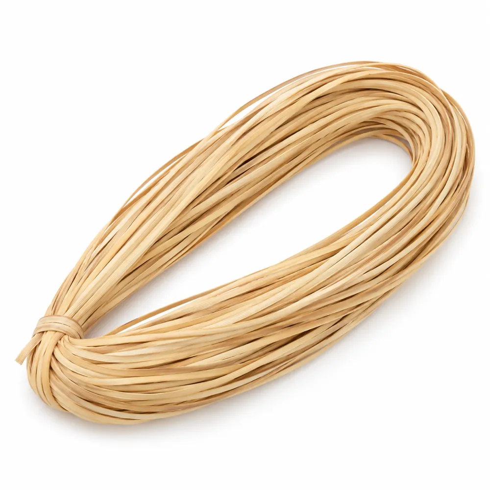 Looped hank of glossy honey-blond strand chair cane, tied at one end, on a white background