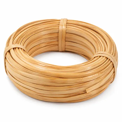 Neat coil of wide, flat, glossy honey-blond binder cane, tied, on a white background