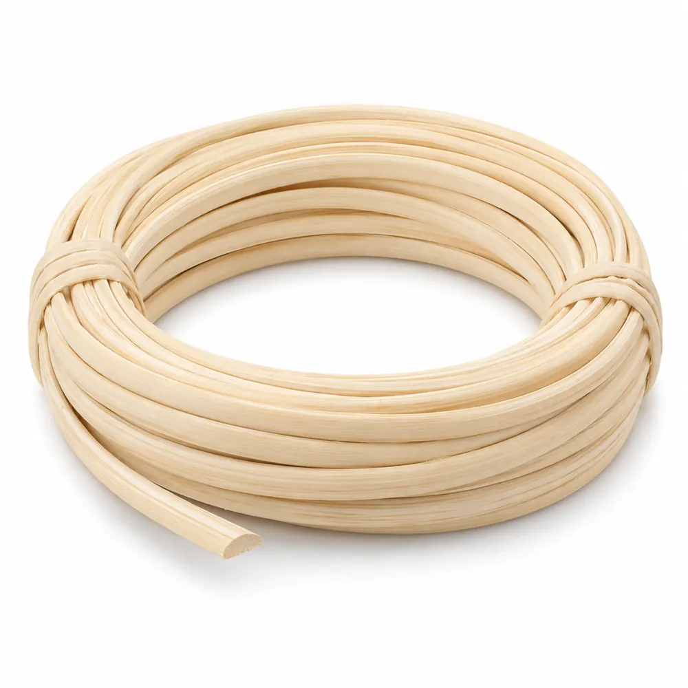 Coil of matte, pale cream flat oval reed, flat on one side and rounded on the other, on a white background