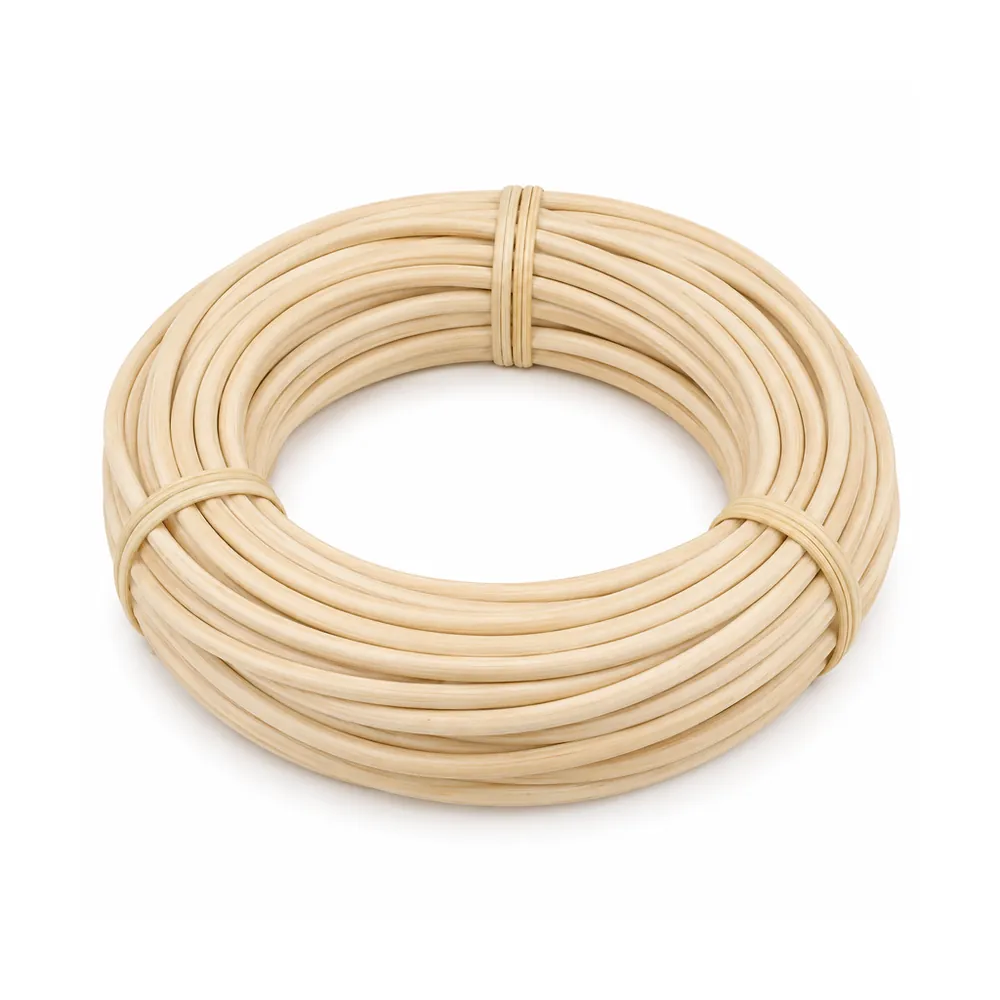 Coil of thick, smooth, matte pale cream round rattan core, tied, on a white background