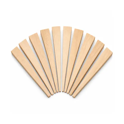 Ten smooth light hardwood caning wedges with thin tapered edges arranged in a fan on a white background