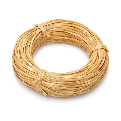 Neat round coil of glossy honey-blond strand chair cane tied in three places, on a white background