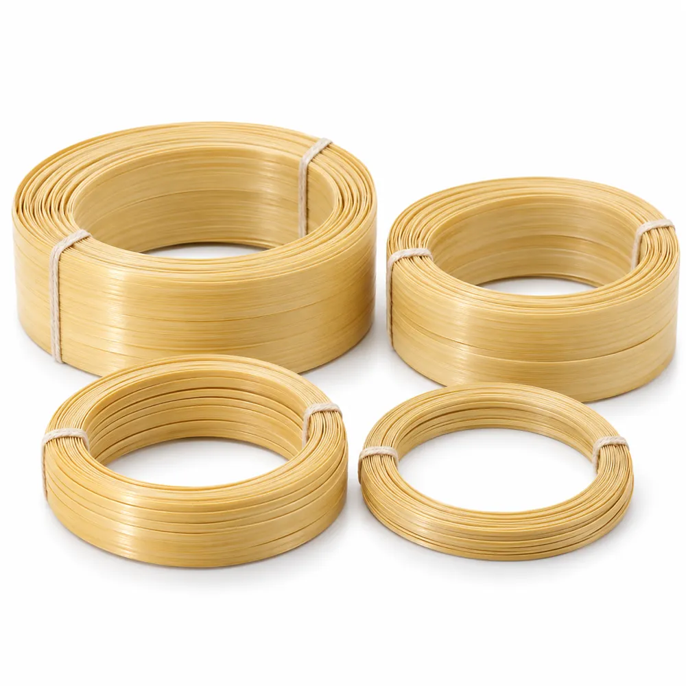 Neat coils of flat split bamboo strips in four widths, glossy pale yellow skin side up, tied with string, on white