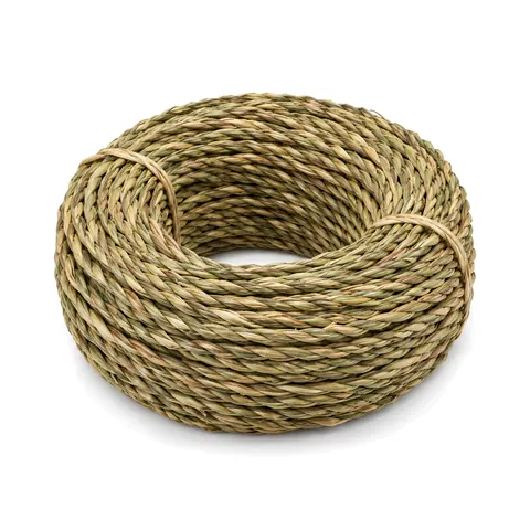 Large coil of twisted natural seagrass rush in green-to-wheat tones on a white background