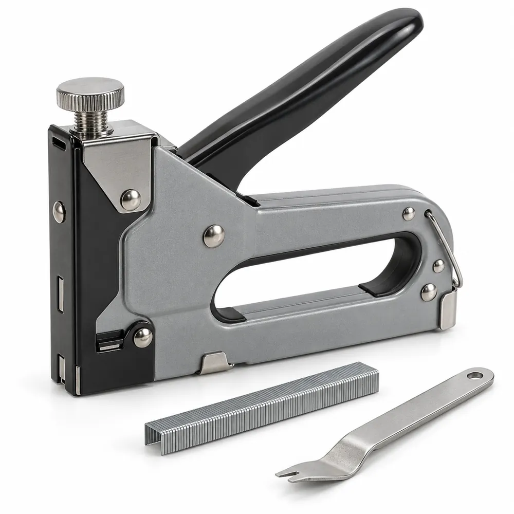 Grey and black manual staple gun with a strip of staples and a flat staple remover beside it, on a white background