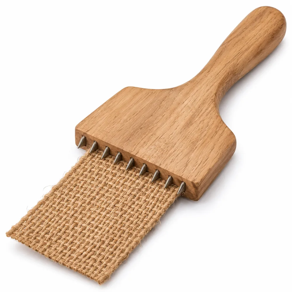 Hardwood webbing stretcher with short metal spikes gripping the end of a jute webbing strip, on a white background