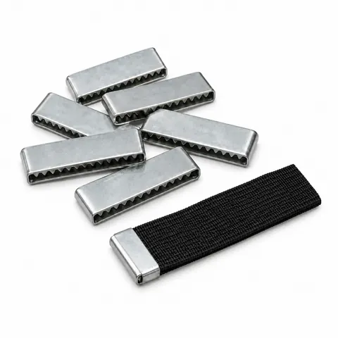 Pile of flat bright metal webbing clips, one pressed onto the cut end of black elastic webbing, on a white background