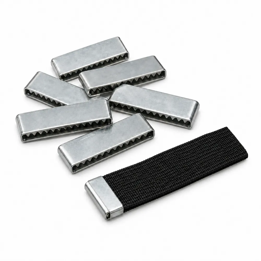 Pile of flat bright metal webbing clips, one pressed onto the cut end of black elastic webbing, on a white background