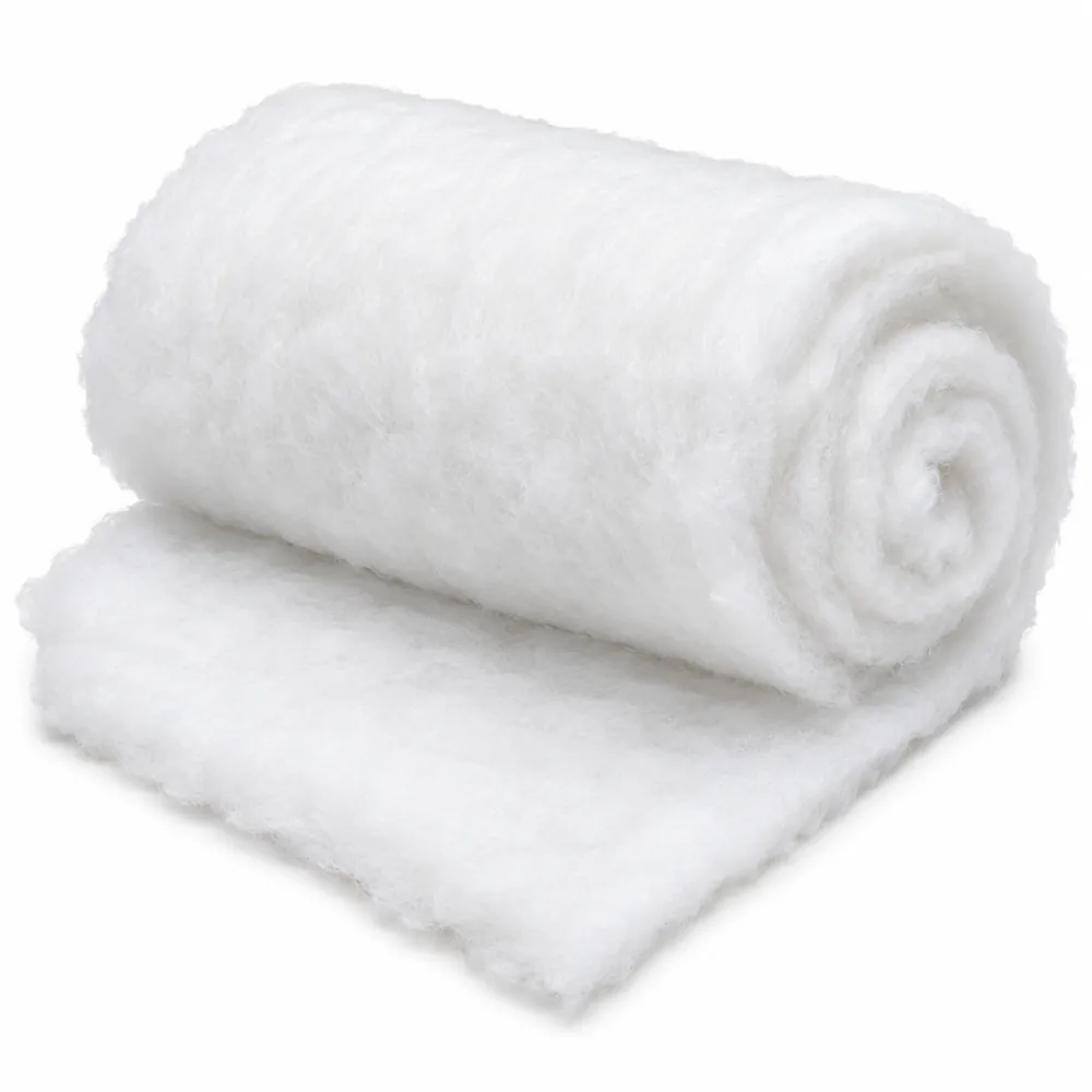 Loosely rolled sheet of fluffy white polyester batting with the end partly unrolled, on a white background