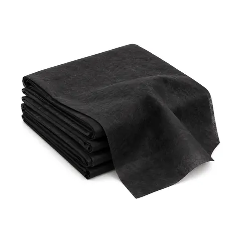 Neatly folded stack of black nonwoven dust cover fabric (cambric) with one end draped forward, on a white background