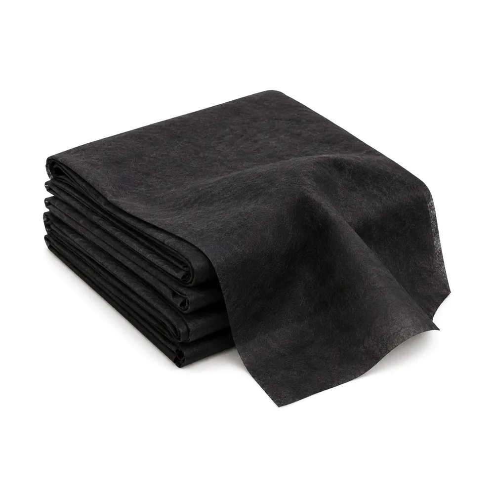 Neatly folded stack of black nonwoven dust cover fabric (cambric) with one end draped forward, on a white background