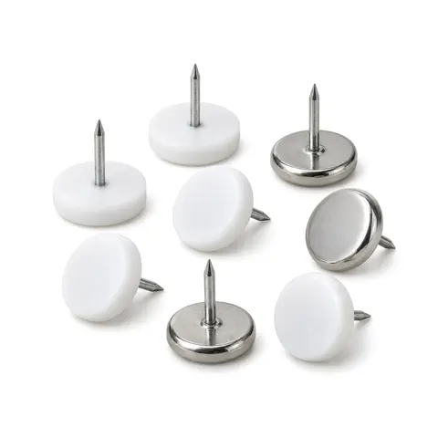 Nail-on furniture glides in white PTFE and silver metal, some upturned to show the nails, on a white background