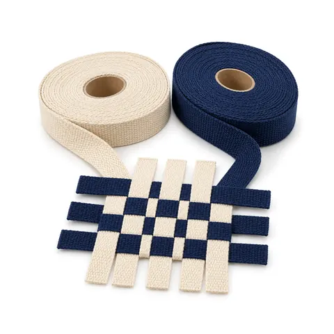 Two rolls of cotton Shaker tape, natural cream and navy, ends woven in a small checkerboard, on a white background